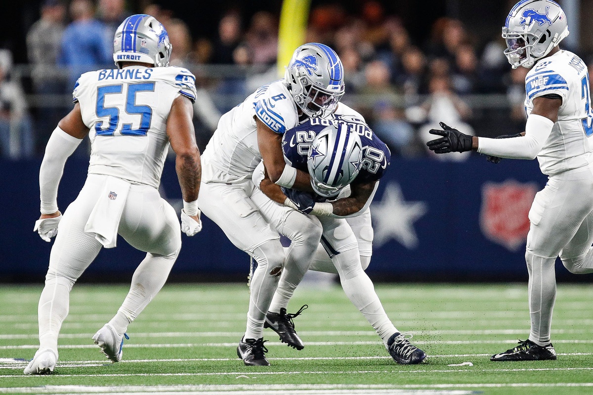 Detroit Lions safety Ifeatu Melifonwu (6) tackles Dallas Cowboys running back Tony Pollard (20) during the second half at AT&T Stadium in Arlington, Texas on Saturday, Dec. 30, 2023.
